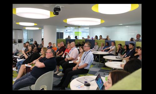 group of professionals sitting down in a conference 