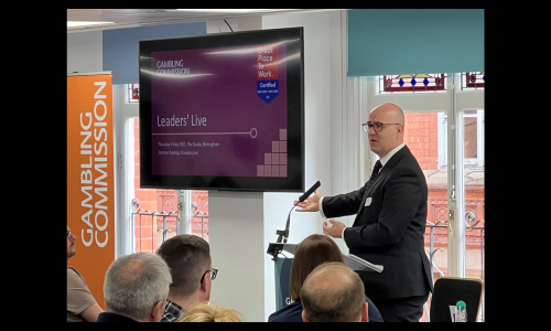 a professional man presenting to a group of other professionals 