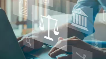 Person typing on laptop with justice icons overlay.