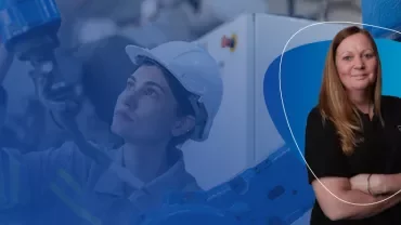 Industrial worker inspecting machinery with person in foreground.