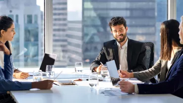 Group of people in a modern office meeting.