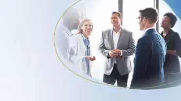 5 people talking in an office setting