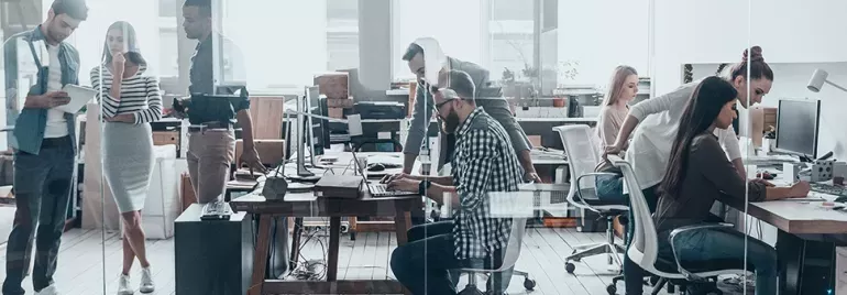 Diverse group of professionals working in an open plan office