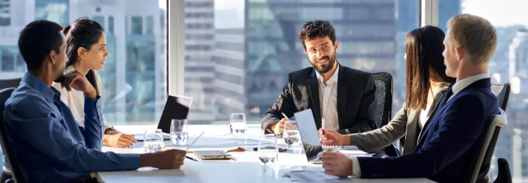 image showing 5 people in a meeting