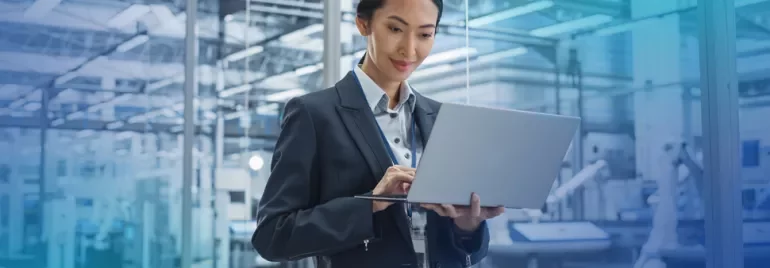 smiling woman in formal business wear holding laptop