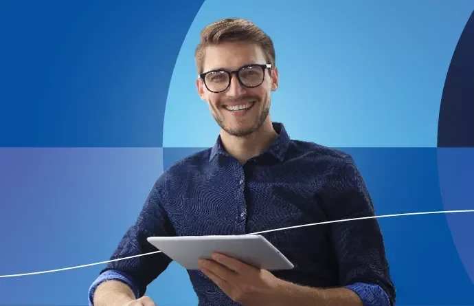 Professional looking person smiling and looking at laptop